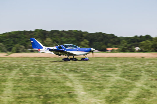 An airplane on a grass runway. The aircraft is ready to fly. It's a transportation for people