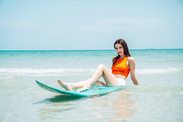 Portrait Smiling Caucasian Woman Posing with Blue Surfboard and Enjoying Holiday Vacation by the Sea, Summer Beach Woman Holding Surfboard.