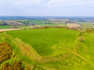 A close up aerial view above the remains of the Iron Age Hillfort in rural Leicestershire, UK in springtime