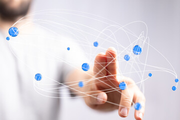 Abstract image of a hand interacting with a network of blue nodes.  Ideal for technology,...