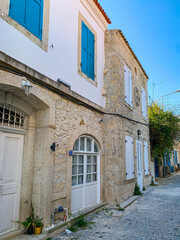  A small, lovely town of Alacati, cobblestone street alleyway, full of vibrant and trendy cafe, restaurants and shops with beautiful colorful decorations 