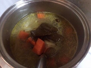 Uncooked Japanese curry in a stainless steel pot isolated, cooking time