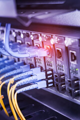 Fiber Optical cables connected to an optic ports and Network cables connected to ethernet ports