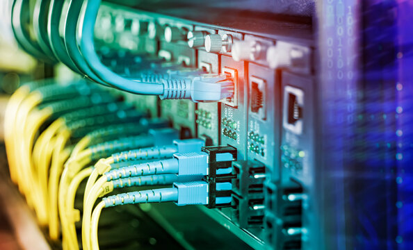 Fiber Optical cables connected to an optic ports and Network cables connected to ethernet ports
