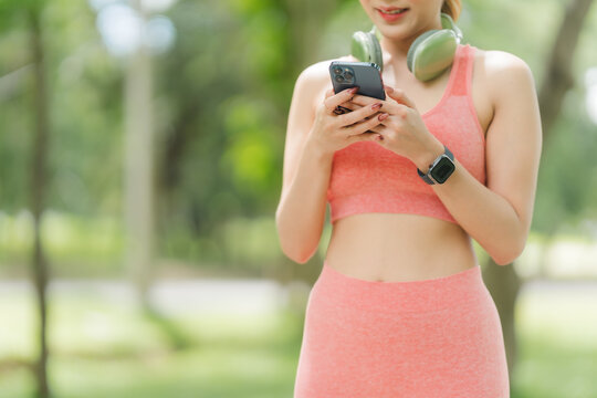 Woman Using Smartphone Outdoors After Workout