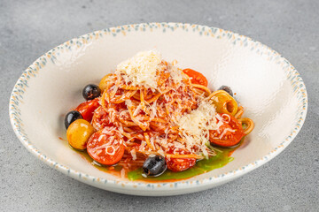 Classic spaghetti with tomato sauce, parmesan cheese, cherry tomatoes, and olives