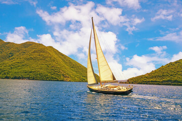 Mediterranean landscape with sailboat on water. Vacations, recreation, sport concepts. Montenegro, Adriatic Sea, Bay of Kotor