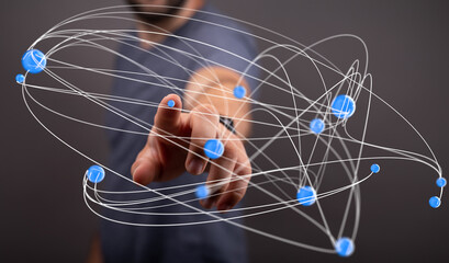 Abstract image of a person interacting with a complex network, representing connections,...