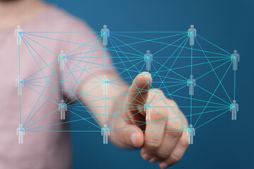 Hand pointing at a digital network of interconnected people, representing global communication and...