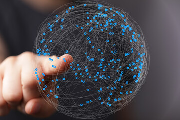 Abstract image of a hand interacting with a digital sphere, representing global network connections...