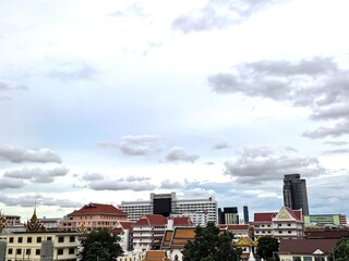 Bangkok Cityscape with Temples and Modern Buildings Under Cloudy Sky