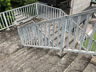 Outdoor Concrete Stairs with Metal Railings and Greenery