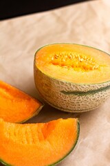 Freshly Sliced Cantaloupe Melon on Parchment Background