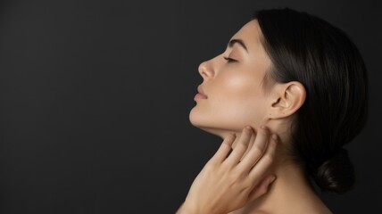 Portrait of young asian female with closed eyes and hands touching neck