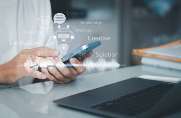 AI chatbot and Artificial intelligence technology concept, man use smartphones to talk with voice to smart robot virtual assistants to trade data in the work process to make the business efficient