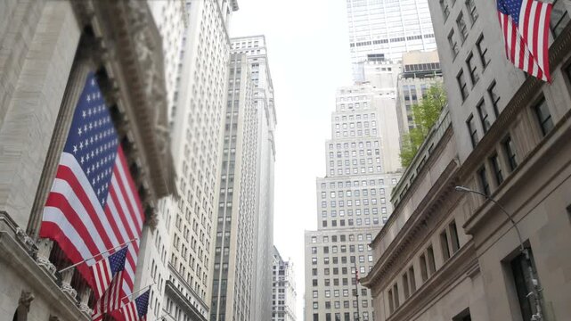 New York City, United States. Lower Manhattan Downtown Financial District urban architecture. Huge big American flag. Wall street Stock Exchange building, USA Stock Market trading.