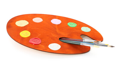 Wooden palette with paints and brushes isolated on white