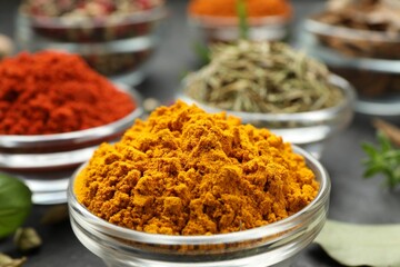 Different aromatic spices on grey table, closeup