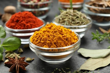 Different aromatic spices on grey table, closeup