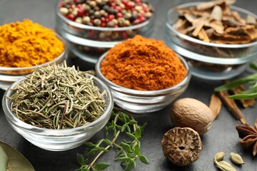 Different aromatic spices on grey table, closeup