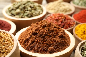 Different aromatic spices in bowls on table, closeup