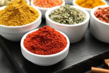 Different aromatic spices in bowls on table, closeup