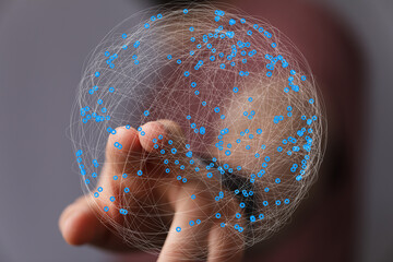 Abstract image of a hand interacting with a digital global network.  Represents connection,...