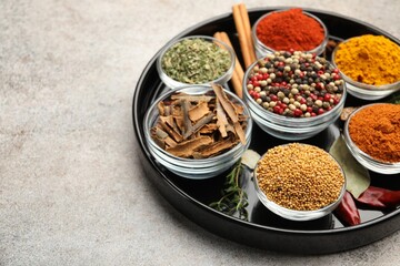 Different aromatic spices on light grey table, closeup. Space for text