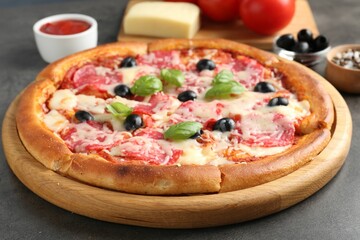 Tasty pizza and ingredients on grey table, closeup