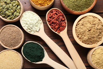 Different superfoods on wooden table, flat lay
