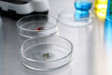Petri dishes with samples on metal table, closeup