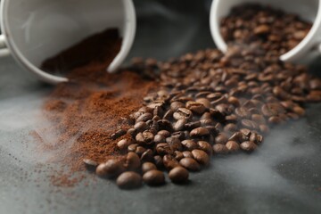 Aromatic ground coffee and beans on black table, closeup