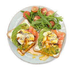 Delicious sandwiches with avocado, poached egg, salmon, tomatoes and arugula isolated on white, top view