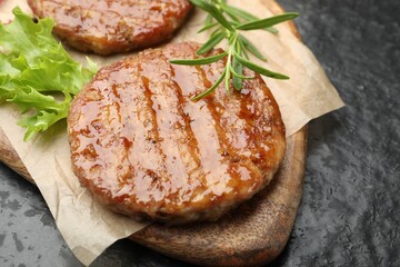 Delicious hamburger patties and spices on black table, closeup