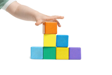 Child playing with colorful cubes on white background, closeup