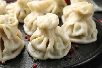 Delicious khinkali with spices on table, closeup