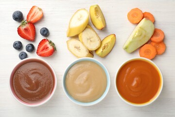 Baby food. Tasty puree in bowls and different ingredients on white wooden table, flat lay