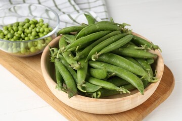 Fresh ripe green peas on white wooden table, closeup