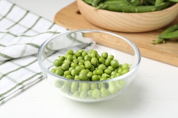 Fresh ripe green peas on white wooden table, closeup