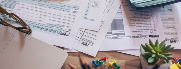 Planning, Budget, and Tax Concept. Individual Income 1040 Tax Form and calculator for individual income. According to United States, season to pay and deadline for tax payment-banner concept.
