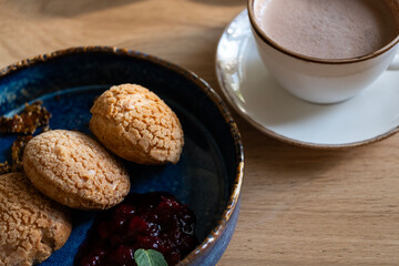 Fresh Pastry with Jam and Cup of Cocoa on Wooden Table