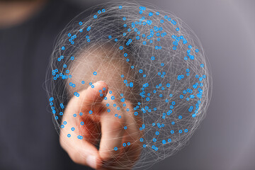 Abstract image of a hand interacting with a digital sphere representing global network connections.