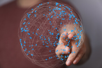 Abstract image of a hand interacting with a digital sphere representing global network connections.