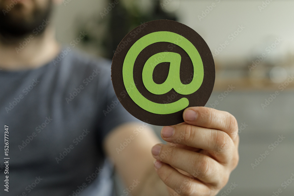 Aufkleber close-up of a person holding a symbol representing email, ideal for contact us pages and communicati