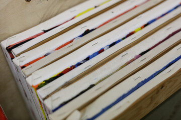 Close-up of a stack of canvases showcasing vibrant abstract art. Perfect for projects about creativity and art.