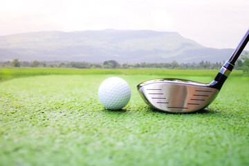 Close-Up of Golf Club and Ball on Green Grass with Scenic Background