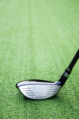 Close-Up of a Golf Club Head on Green Turf Surface