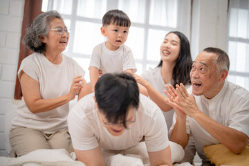 Fototapeta premium Family gathering with joyful interactions among multiple generations in a cozy home setting