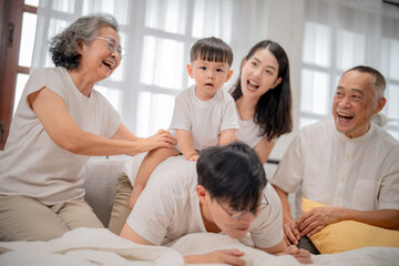 Fototapeta premium Family bonding moments in a cozy living room with laughter and joy on a sunny afternoon