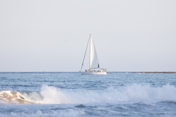 sailboat on the sea at sunset.
